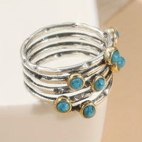 Zilveren ring met turquoise edelstenen en goudaccent