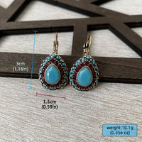 Vintage oorbellen met turquoise druppel en rode strass
