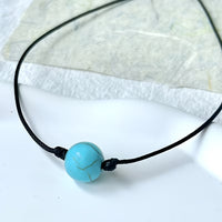 Bohemian lariat ketting van bruin koord met turkooizen kralen