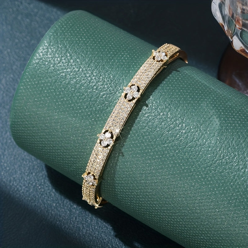 Gouden bangle armband met bloemen en zirkonia