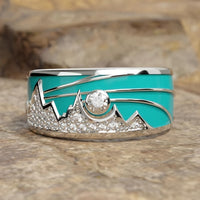 Zilveren ring met turquoise emaille berg-zonmotief en zirkonia