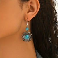 Zilveren boho hartoorbellen met vlinder en turquoise