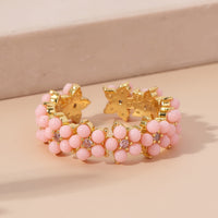 Gouden ring met turquoise kralen bloemmotief