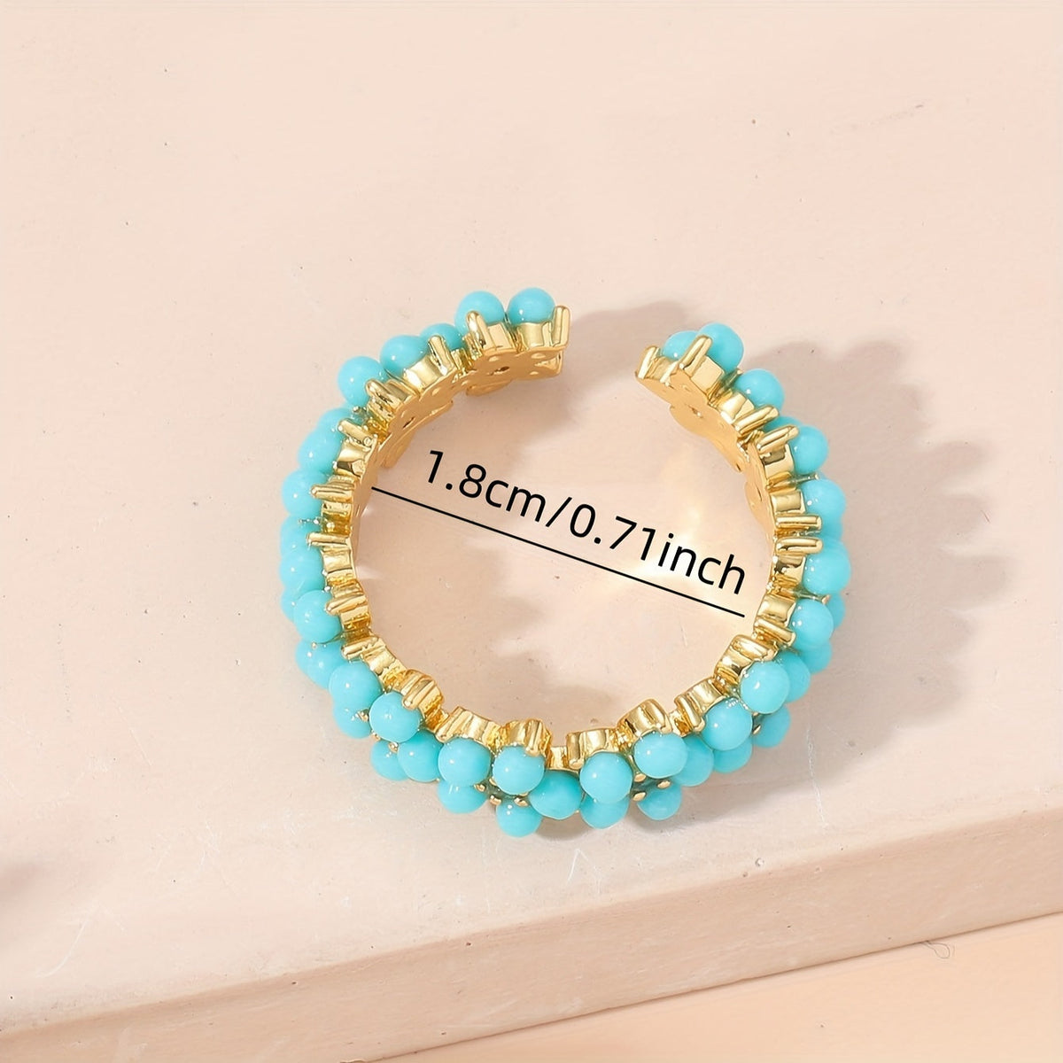 Gouden ring met turquoise kralen bloemmotief