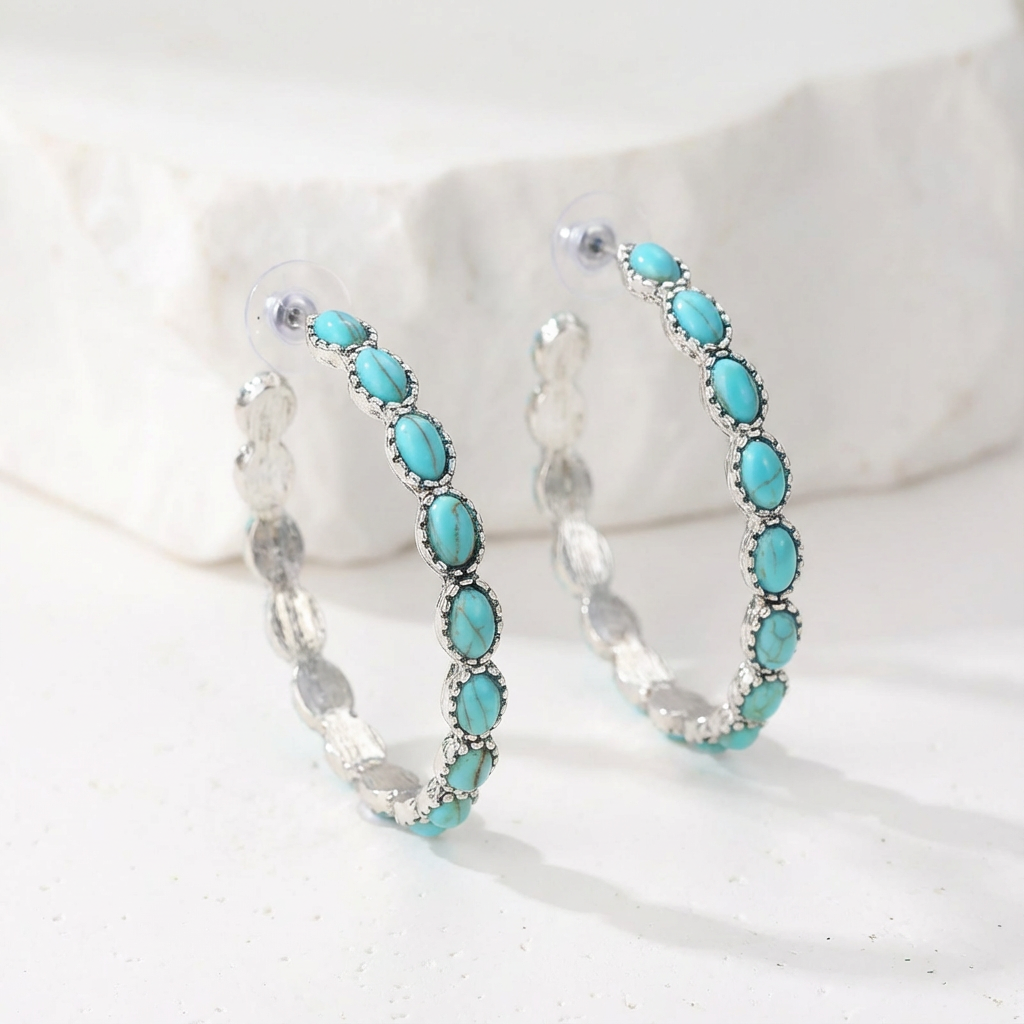 Zilveren oorbellen met ovale turquoise edelstenen