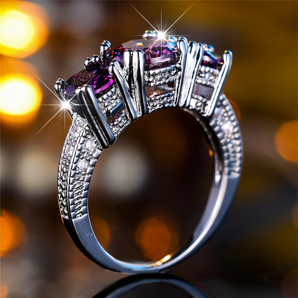 Zilveren ring met rij paarse edelstenen