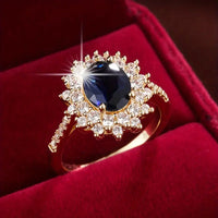 Gouden vintage ring met blauwe steen en zirkonia