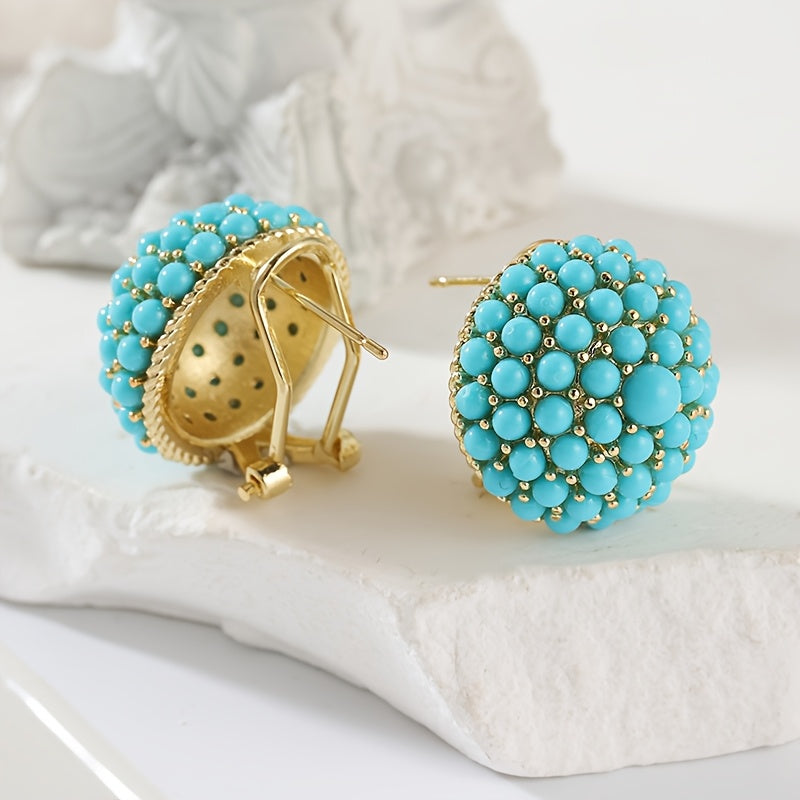 Gouden oorbellen met turquoise koepel van kralen