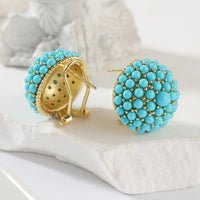 Gouden oorbellen met turquoise koepel van kralen