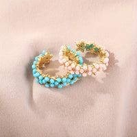 Gouden ring met turquoise kralen bloemmotief
