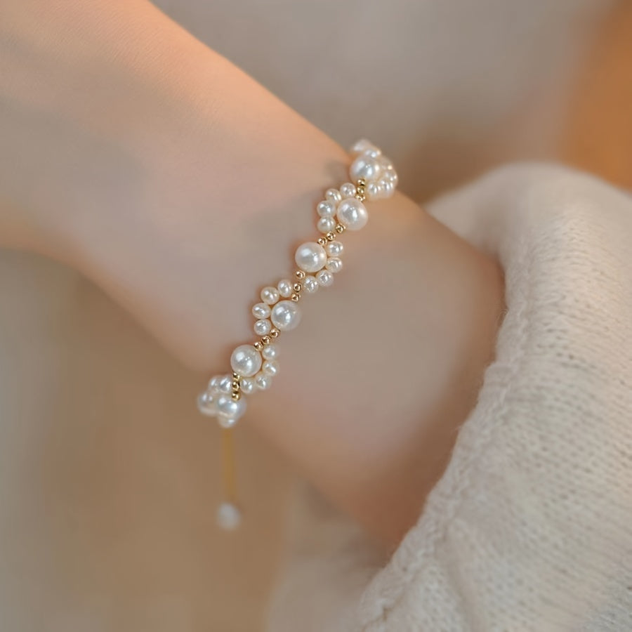Gouden armband met parelclusters en hangbedeltje