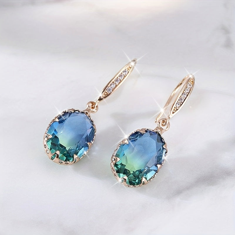 Gouden oorbellen met ovale blauwgroene steen