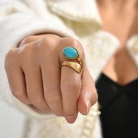 Gouden bypass ring met ovale turquoise steen