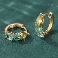 Gouden oorbellen met gele en blauwgroene edelstenen