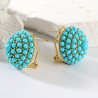 Gouden oorbellen met turquoise koepel van kralen