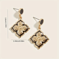 Gouden vintage oorbellen met zwart emaille klaverbloem