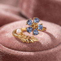 Gouden open ring met blauwe bloem, parel en blad