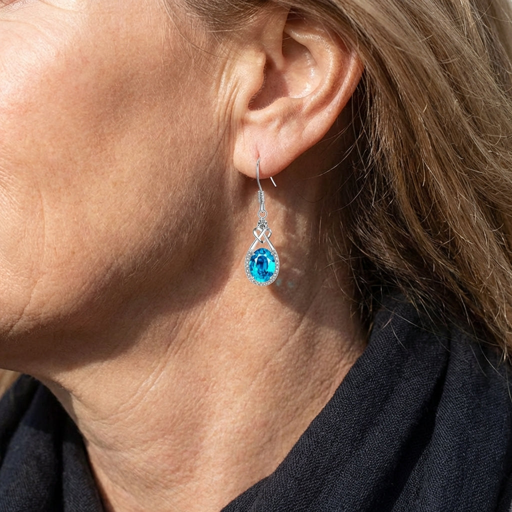 Zilveren oorbellen met blauwe ovale edelsteen