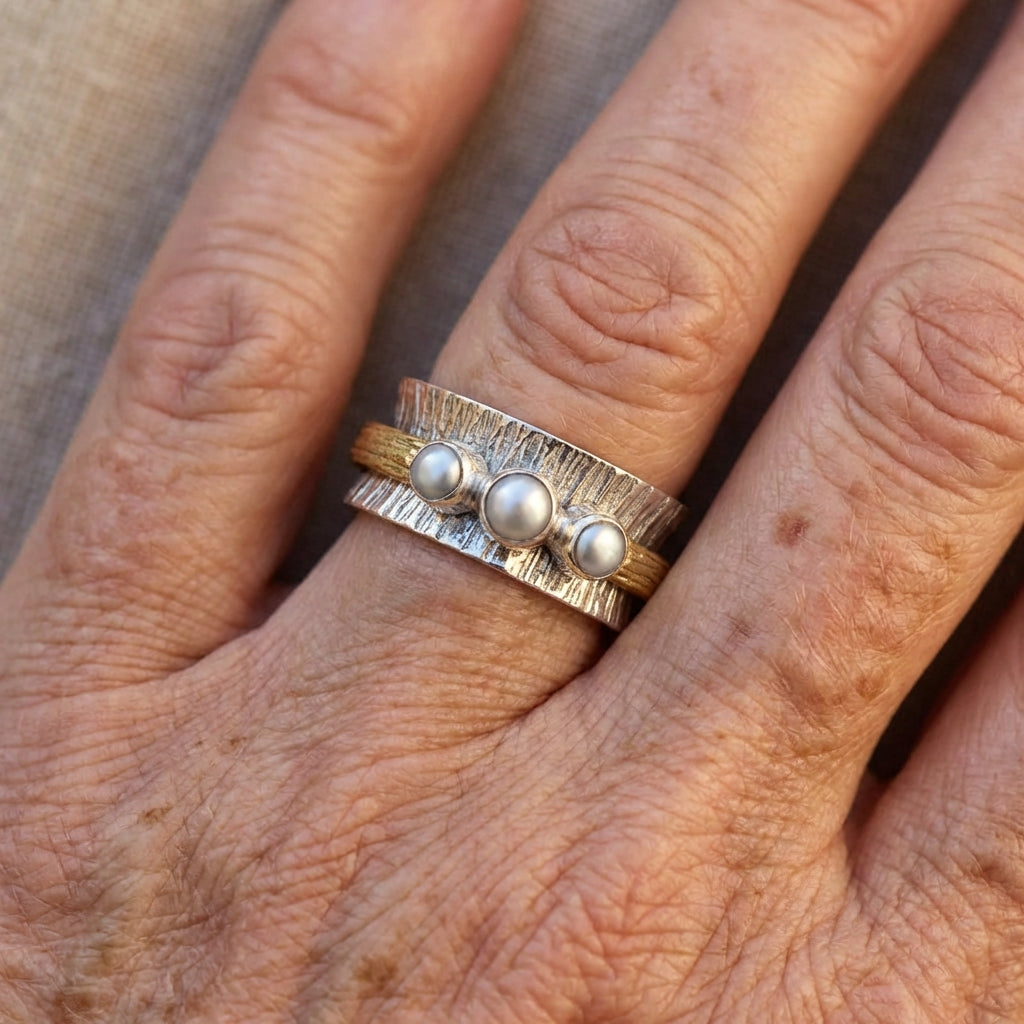 Zilveren ring met parels en goudkleurige spinner band