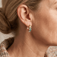 Gouden oorbellen met gele en blauwgroene edelstenen