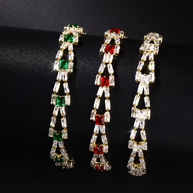 Gouden armband met groene en heldere edelstenen