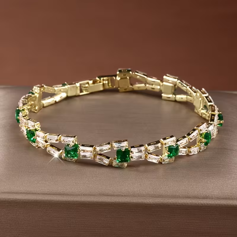 Gouden armband met groene en heldere edelstenen