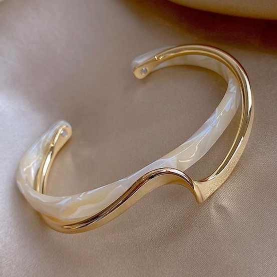 Gouden armband met witte parelmoer en open vorm