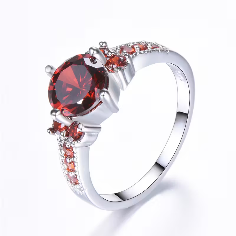Gouden halo ring met ovale rode edelsteen