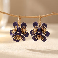 Gouden oorbellen met paarse emaille bloemen