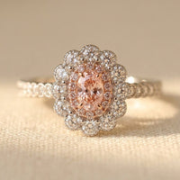 Roségouden ring met roze ovale steen en bloemhalo