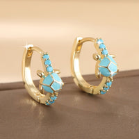 Gouden oorbellen met turquoise schildpadje