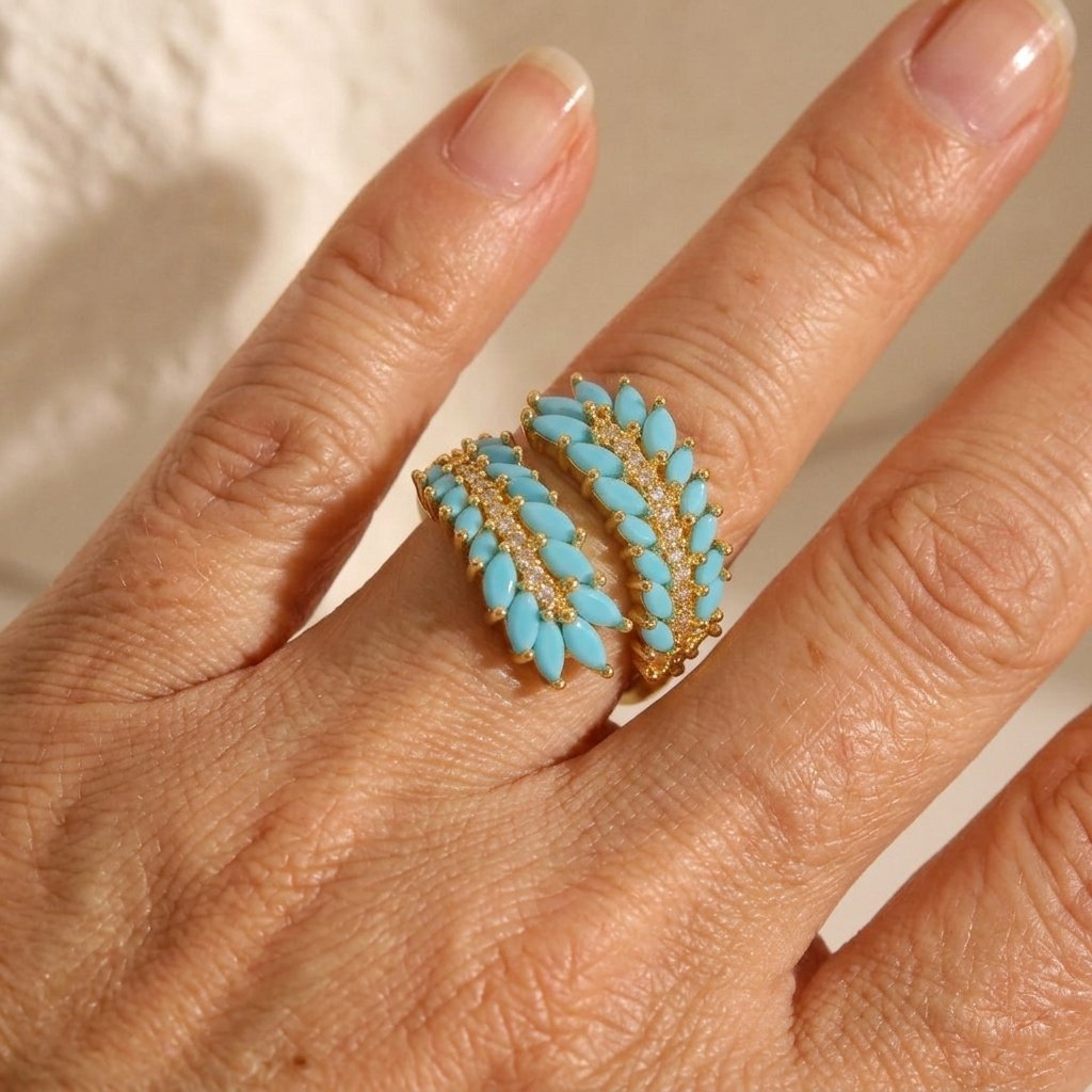 Gouden bypass ring met turkoois en zirkonia