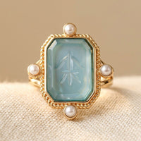 Gouden ring met blauwe edelsteen en parels