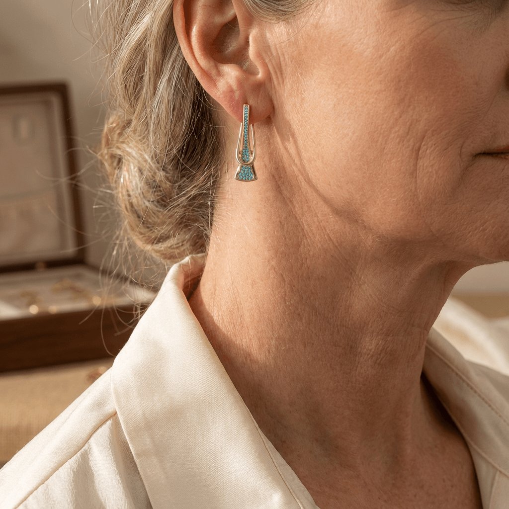 Gouden oorbellen met turquoise en gekruist design