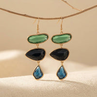 Gouden oorbellen met groene, zwarte en blauwe stenen