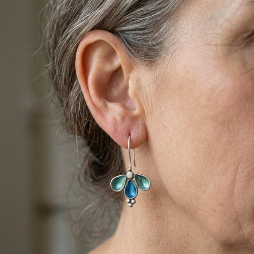 Asymmetrische gouden oorbellen met groene en blauwe stenen