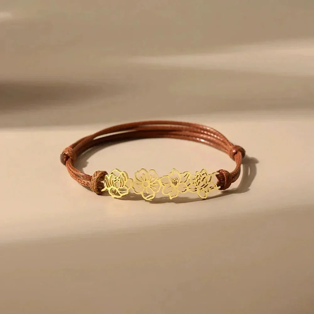 Bruine koord armband met gouden bloemen
