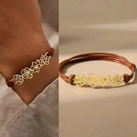 Bruine koord armband met gouden bloemen