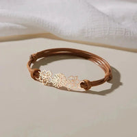 Bruine koord armband met gouden bloemen